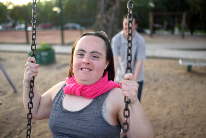 young boyfriends enjoying swinging